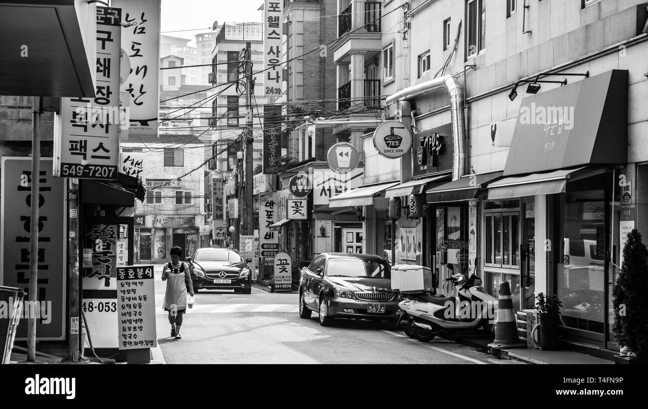 Seoul, South Korea - June 16, 2017: Elderly woman walking down a small street in downtown in Seoul. Stock Photo