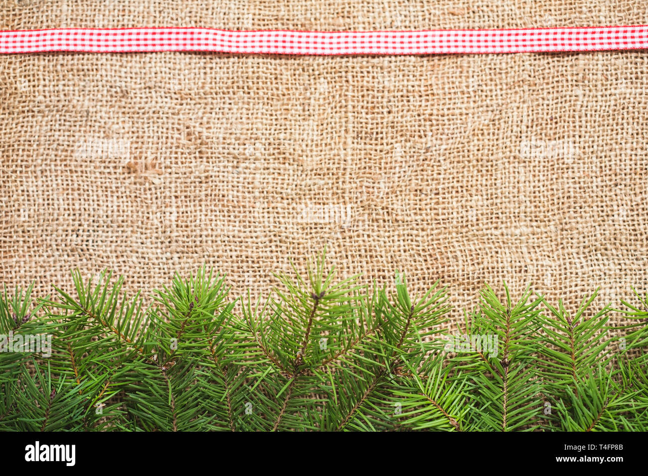 Christmas background with burlap and fir branch Stock Photo