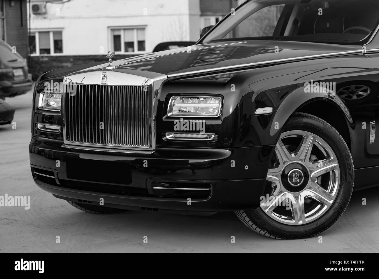 Novosibirsk, Russia - 04.11.2019: Front view of new a very expensive luxury Rolls Royce Phantom car, a long black limousine, model outdoors, prepared  Stock Photo
