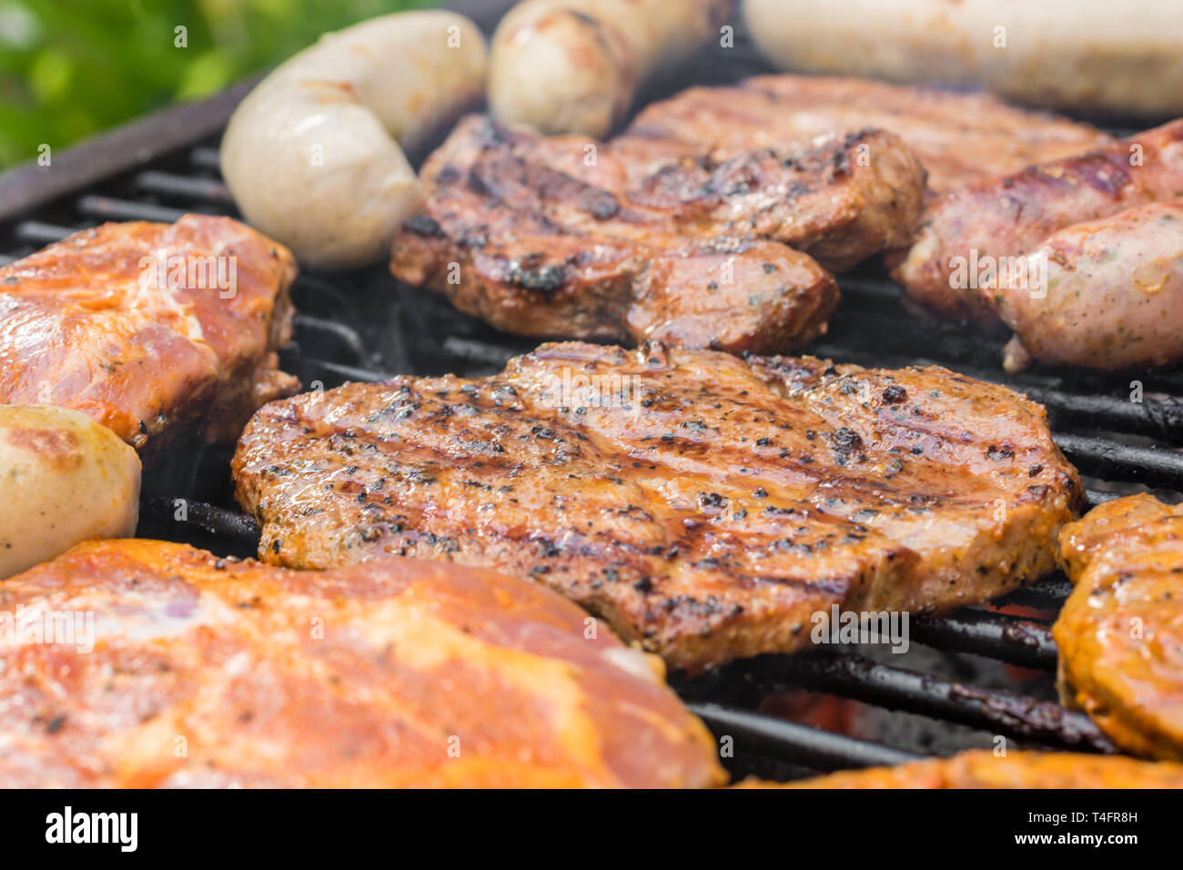 Grill grate covered with different types of meat Stock Photo Alamy
