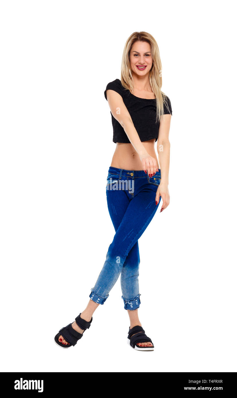 Front view on a young blonde in jeans. A girl is dancing and posing ...