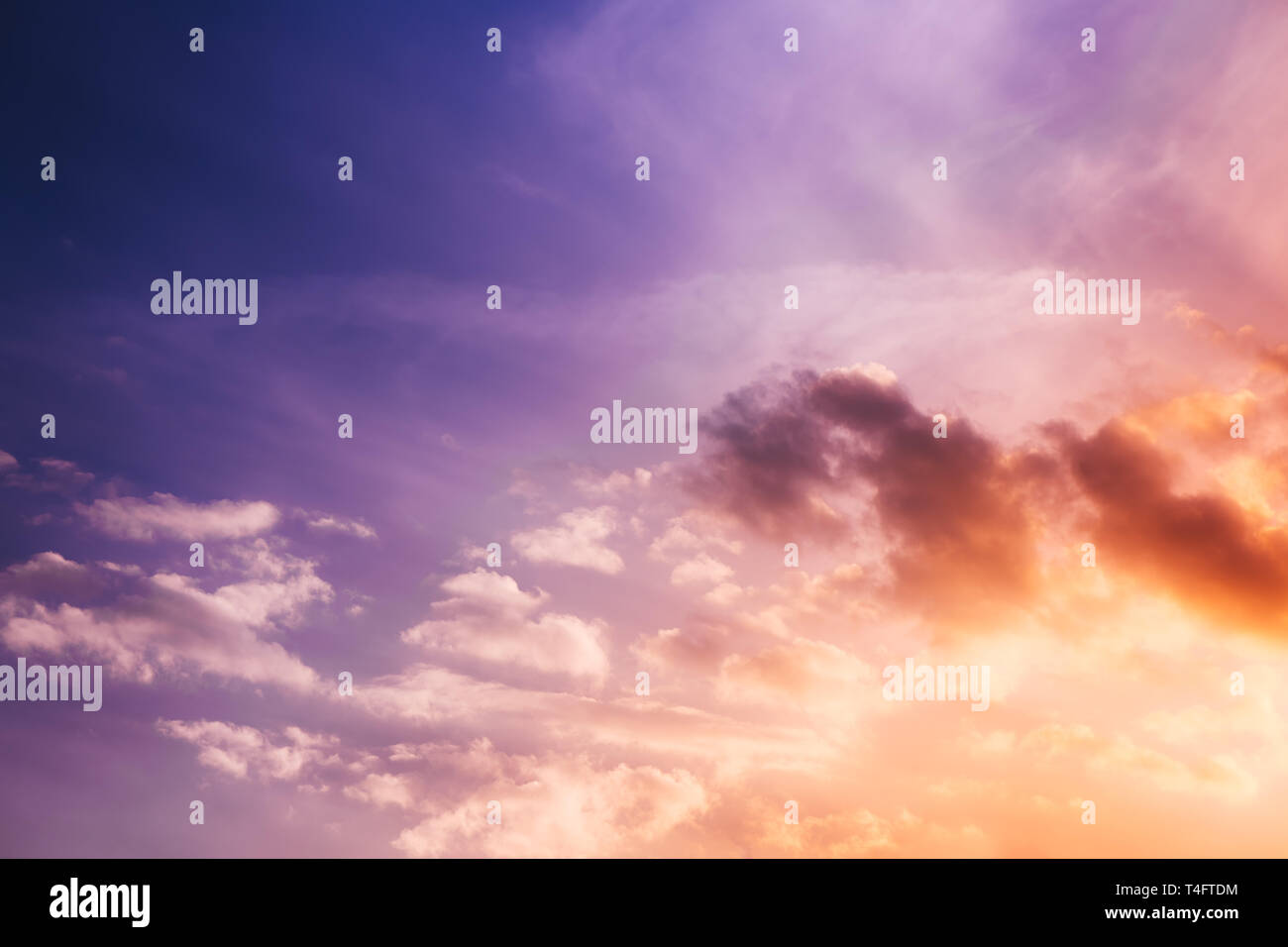 Purple sunset sky with clouds and sunlight rays Stock Photo