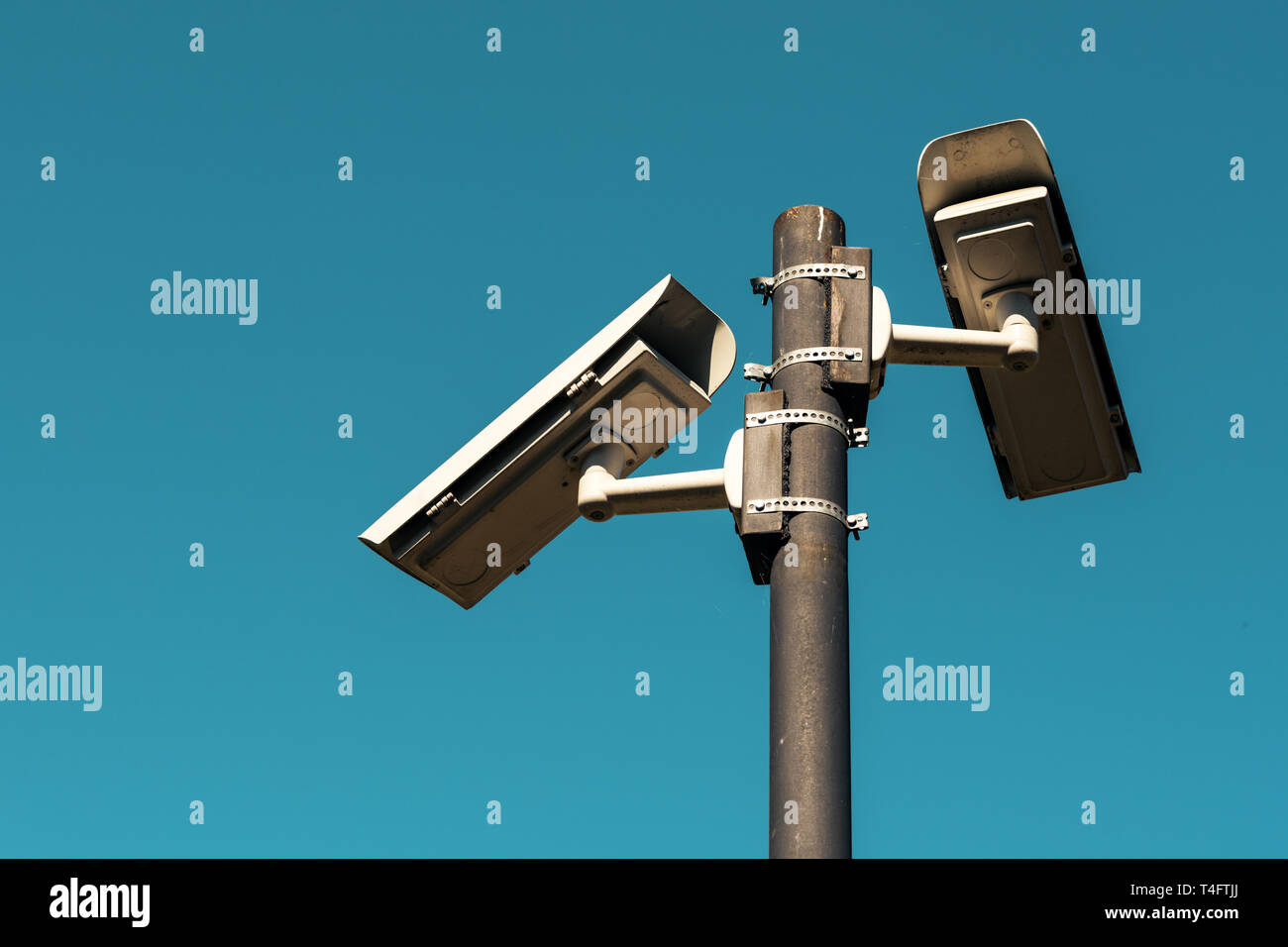 Security cameras with blue sky as background, surveillance and private