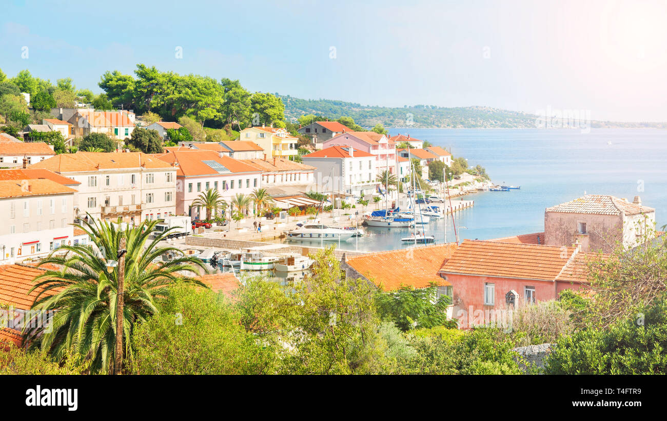 panoramic view of small fishing village with beautiful houses with orange tiled roofs on sunny summer day, Sali, Dugi island, Croatia Stock Photo