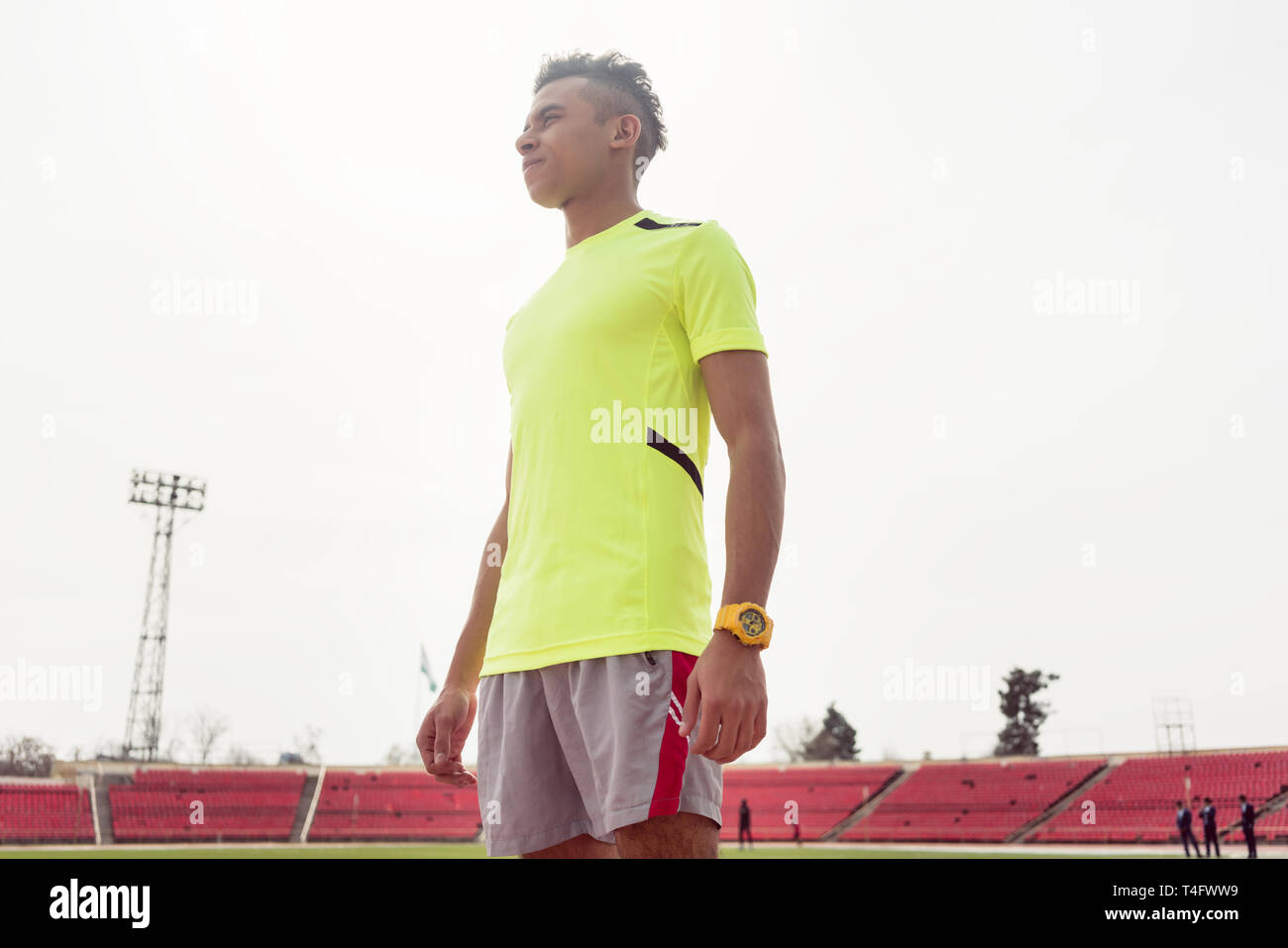 Young sportsman standing on ground Stock Photo