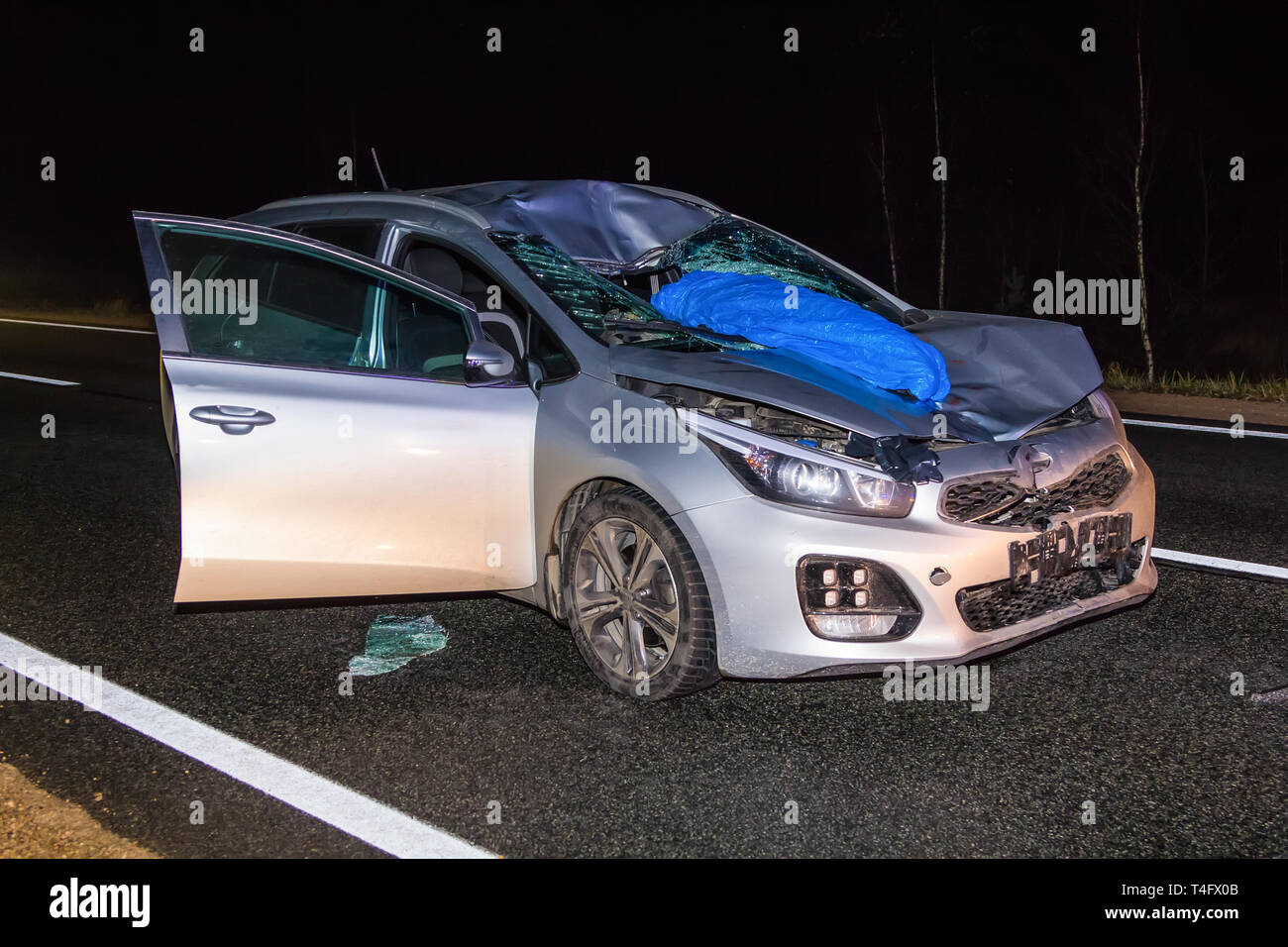 car hit a pedestrian on the highway that was walking along the road without a reflector late at night Stock Photo