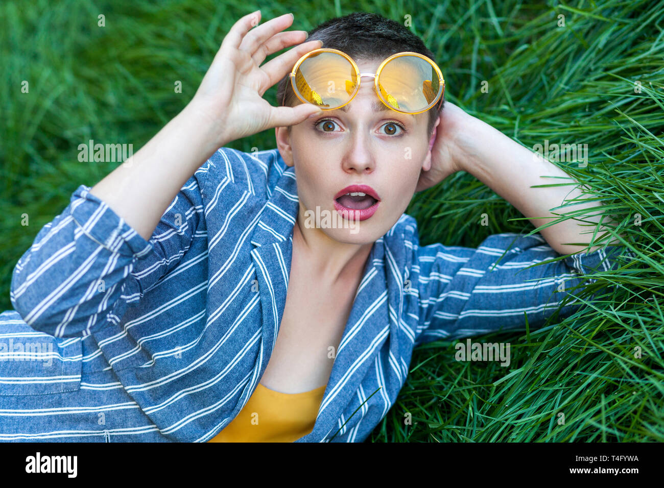 Portrait Of Surprised Cute Young Woman With Short Hair In