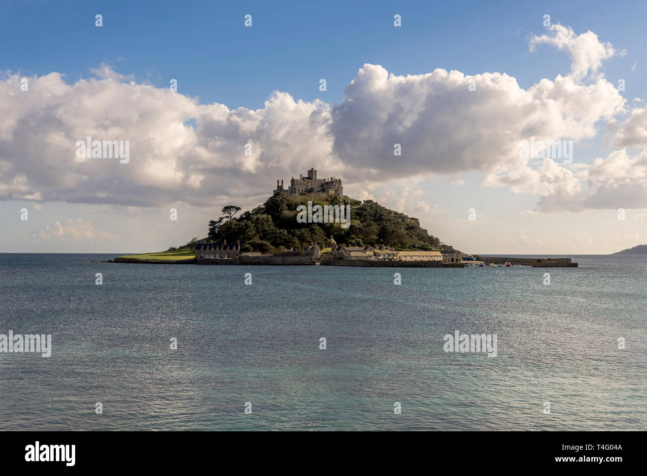 The beautiful & picturesque island of St.Michaels mount Marazion Cornwall UK Europe in beautiful sunshine & blue skies with puffy white clouds . Stock Photo