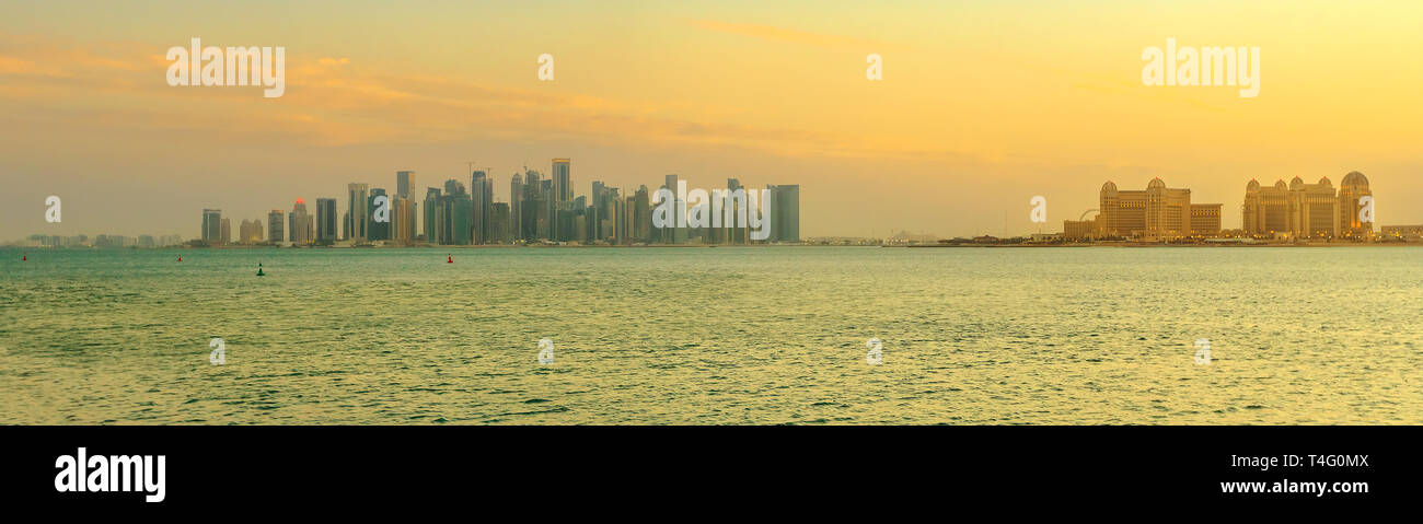 Banner landscape of Doha West Bay skyline with luxurious resort hotel at twilight sky from Porto Arabia, The Pearl-Qatar's main harbor in Doha city Stock Photo