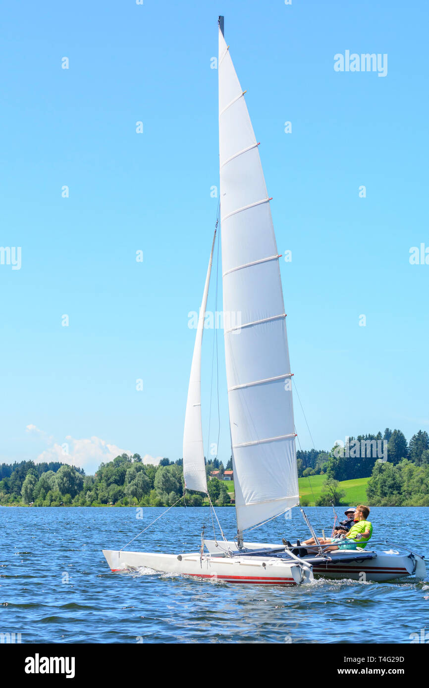 Catamaran sailing on inland lake in summertime Stock Photo