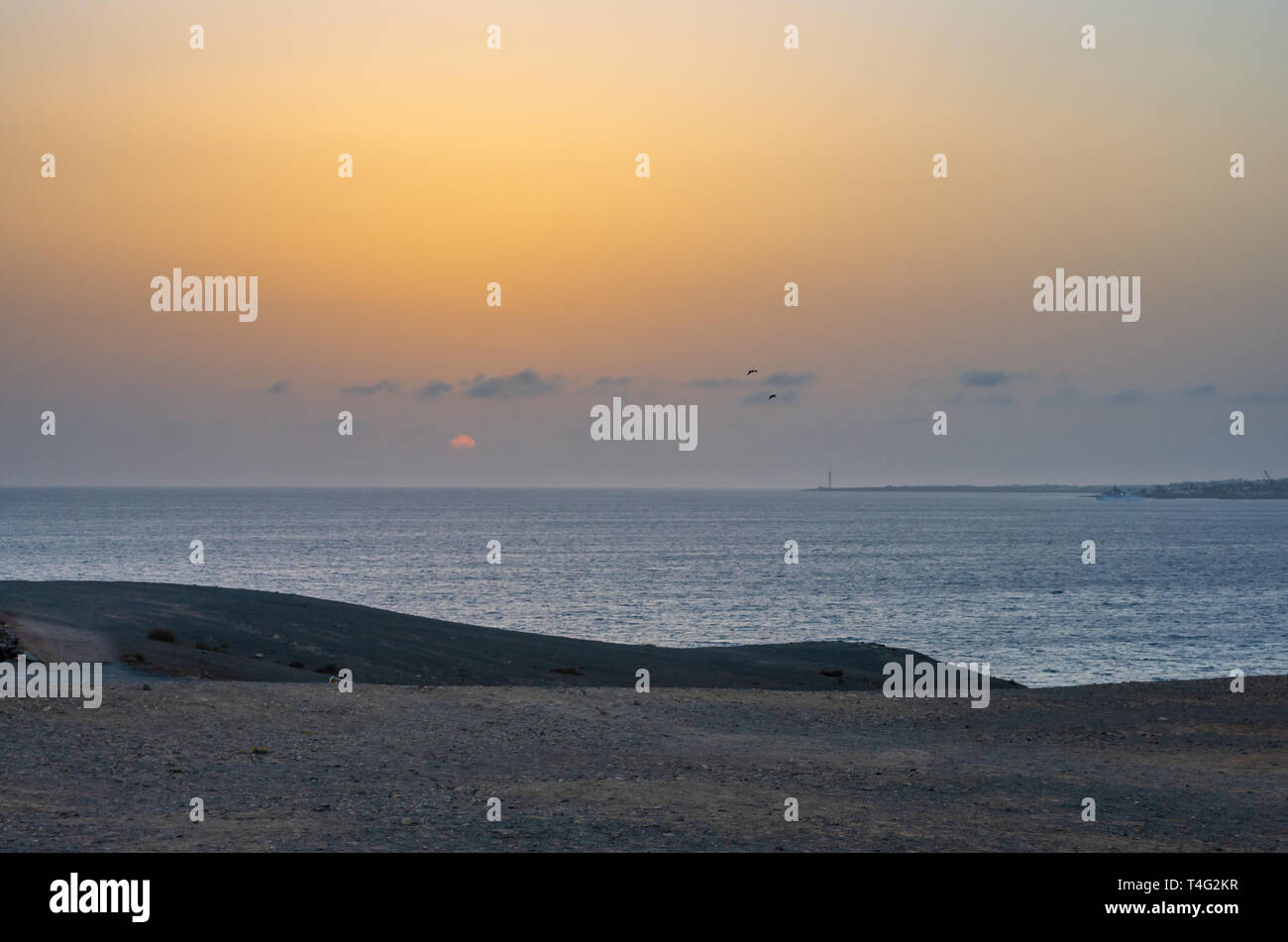 Landscape of a sunset in the sea with lighthouse and boat Stock Photo ...