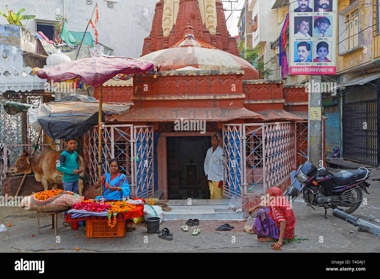 UDAIPUR, INDIA, November 5, 2017 : A family starts on a motorbike in front of a small store of the traditional market in Udaipur, Rajasthan. Stock Photo