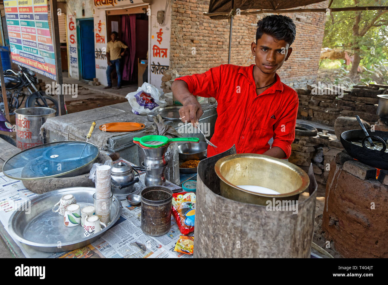 LAKHERI, INDIA, November 7, 2017 : A young man prepares masala tea in an outdoor shop. Stock Photo