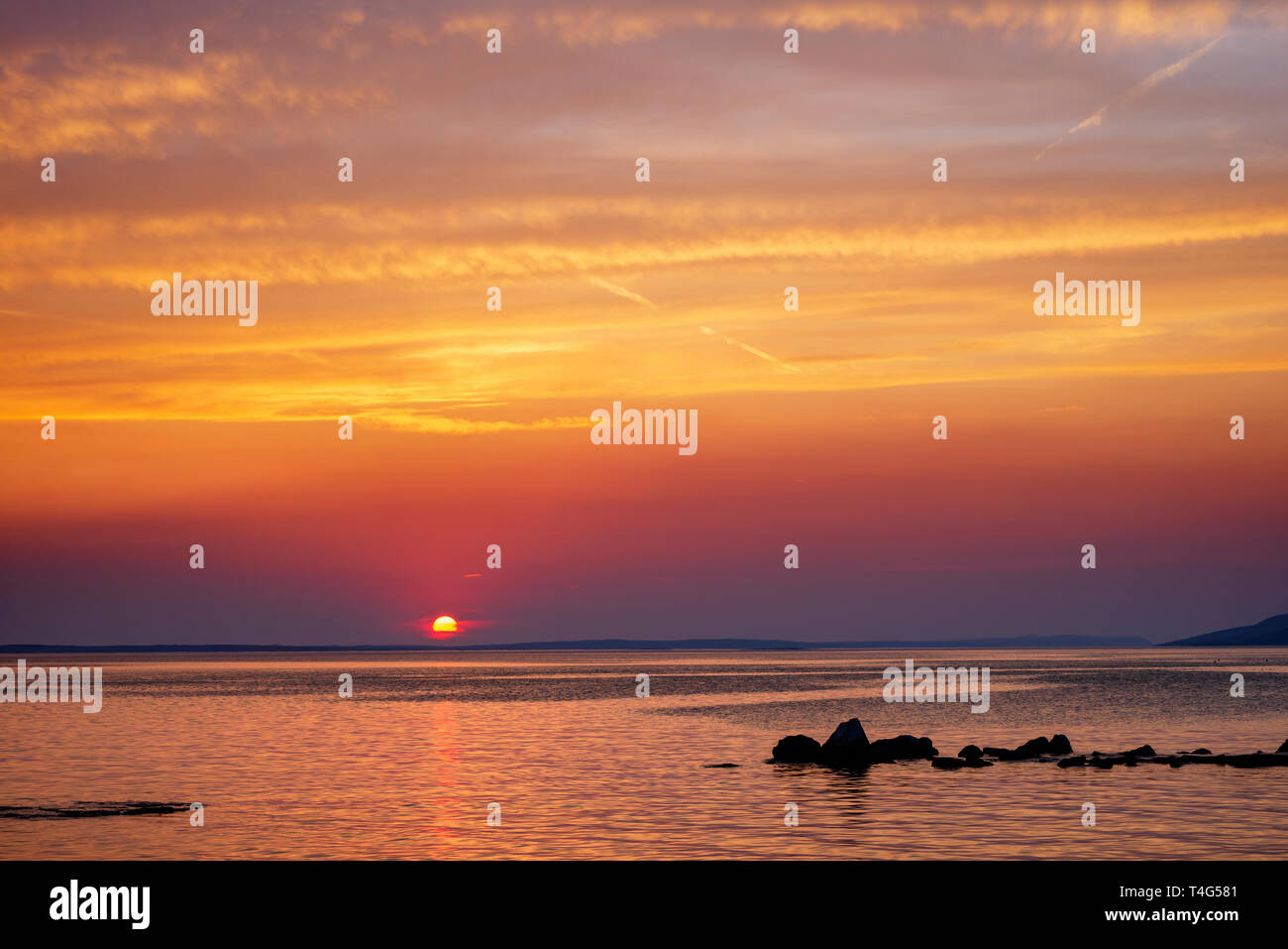 Sunset over Adriatic Sea with colourful dramatic sky near Starigrad in Dalmatia, Croatia. Stock Photo
