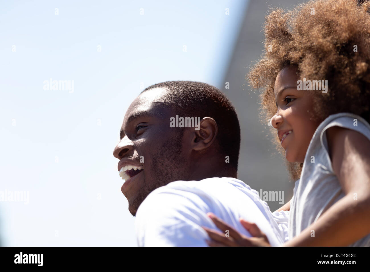 Close up smiling African American father having fun with daughter Stock Photo
