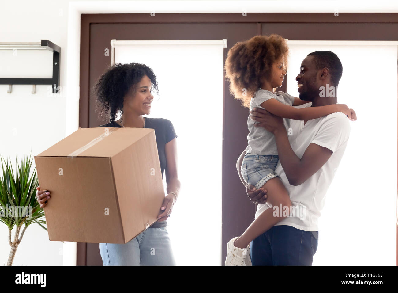 Happy African American family moving in new own house Stock Photo - Alamy