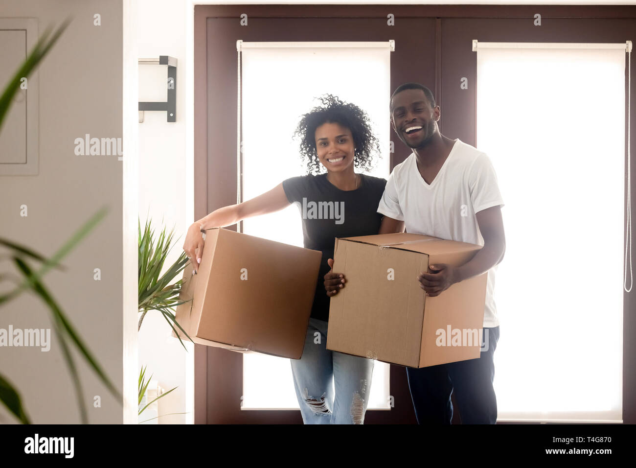 Portrait happy African American couple on moving day in new house Stock ...