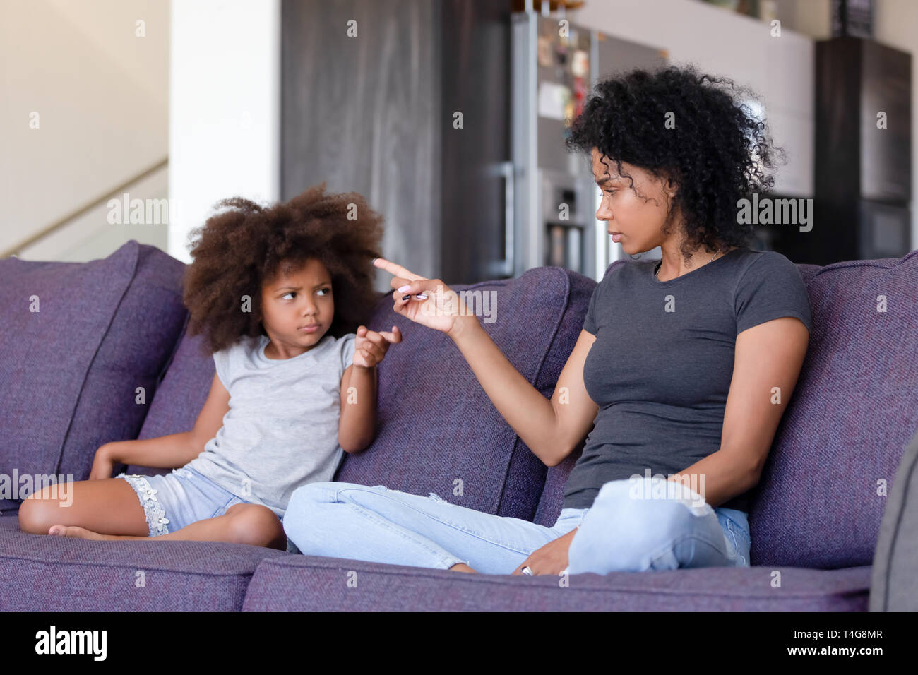 Upset African American mother and daughter quarreling at home Stock Photo