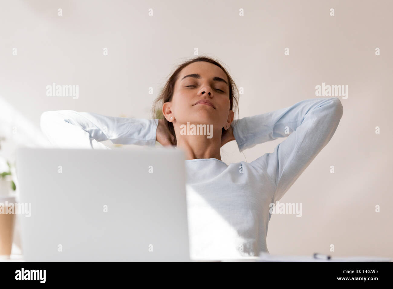 Beautiful woman relaxing on chair at work with eyes closed Stock Photo ...