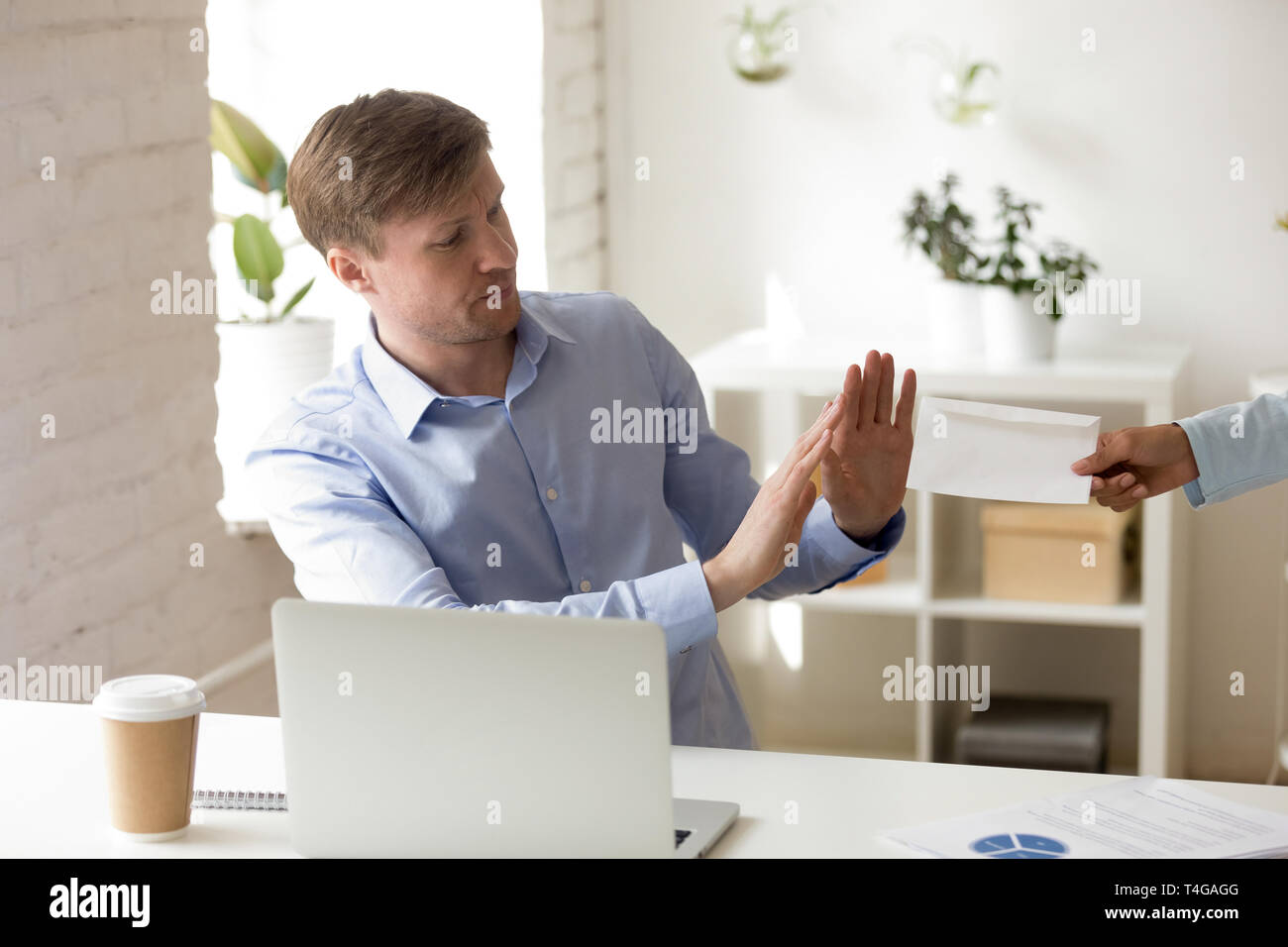 Bussiness man refuses to accept bribery envelope Stock Photo