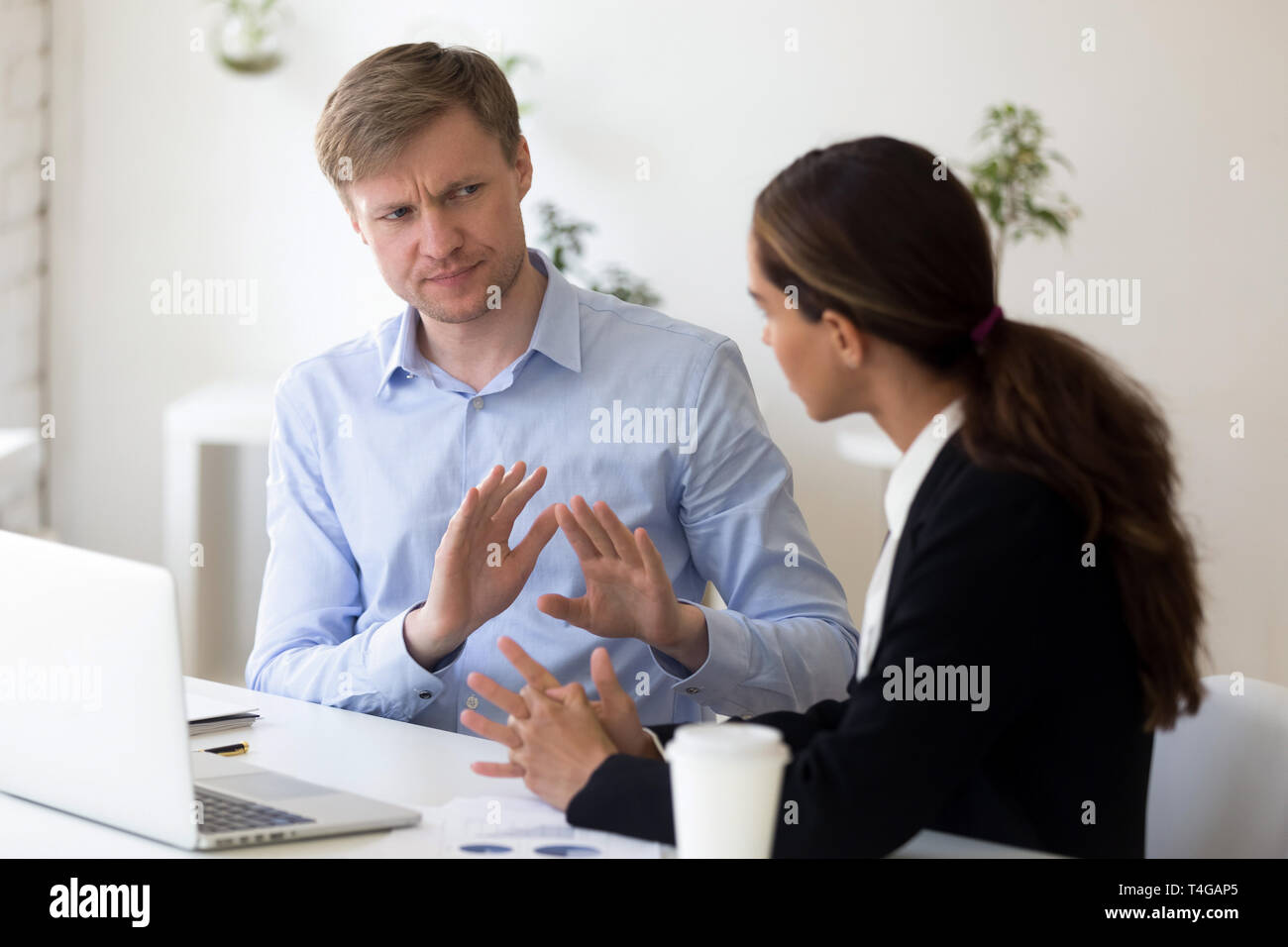 Millennial businessman rejecting giving interview to journalist Stock Photo