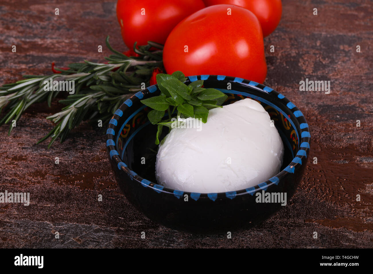 Italian Mozzarella cheese ball served basil and tomatoes Stock Photo Alamy