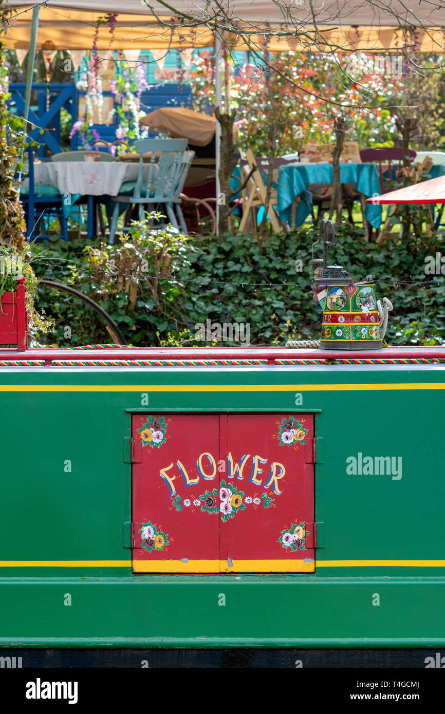 Canal boat alongside Janes Enchanted Tea Garden  on the oxford canal on a spring morning. Kirtlington, Oxfordshire, England Stock Photo