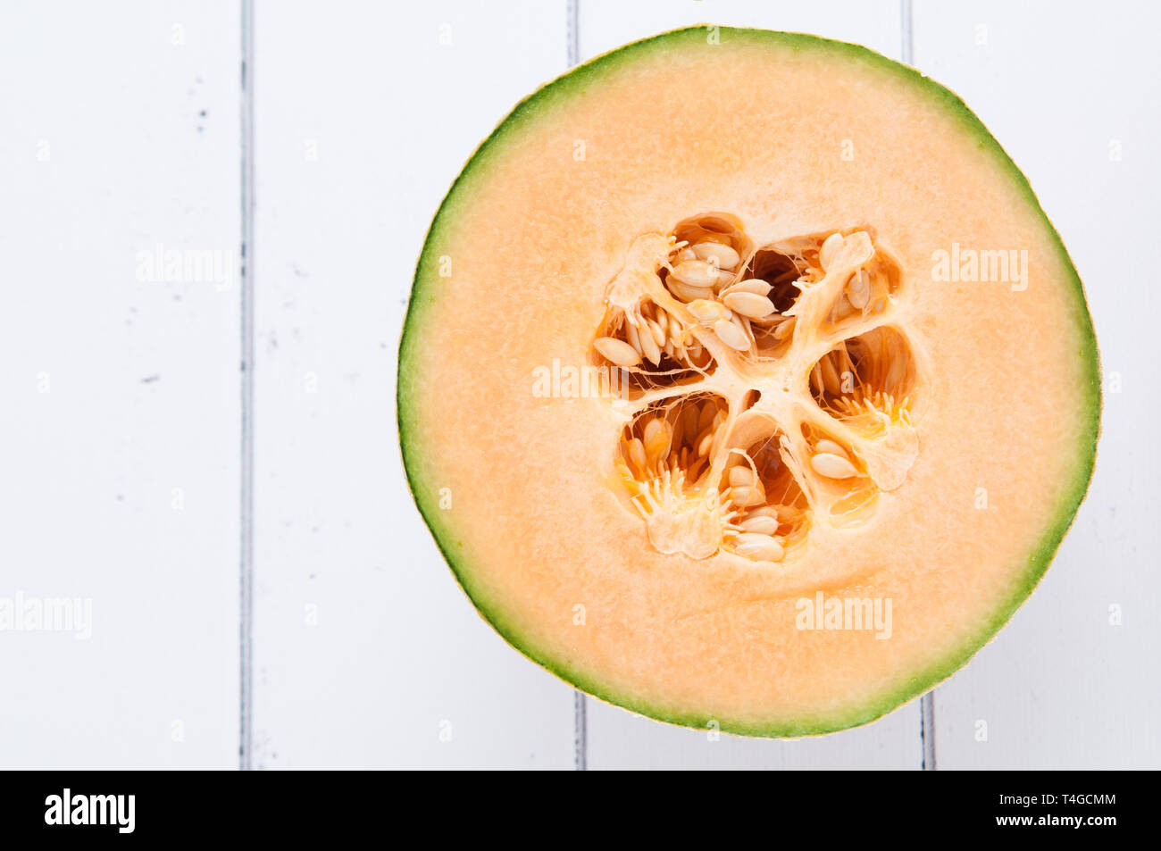 cantelope melon on a white wooden background Stock Photo