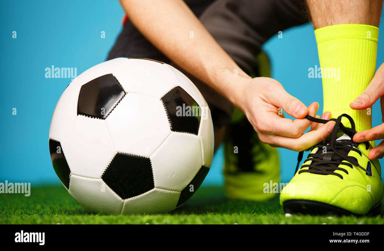 Soccer player tying his shoes Stock Photo Alamy