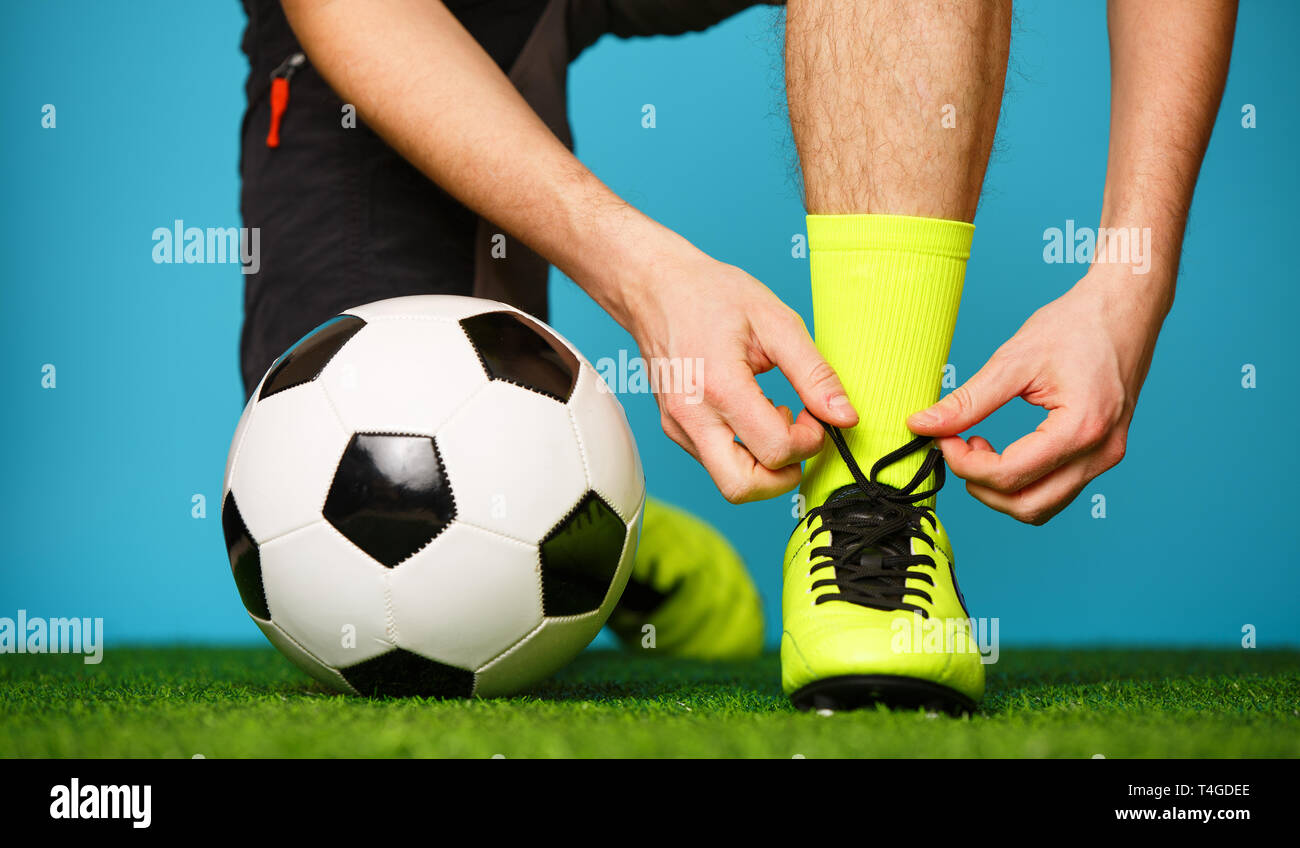 Soccer player tying his shoes Stock Photo Alamy