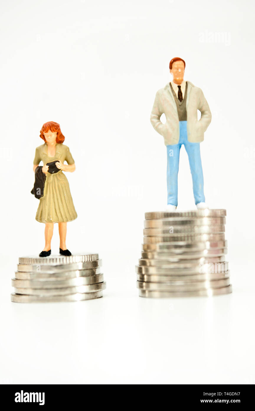 man and woman figurine standing on coins, gender pay gap concept Stock Photo