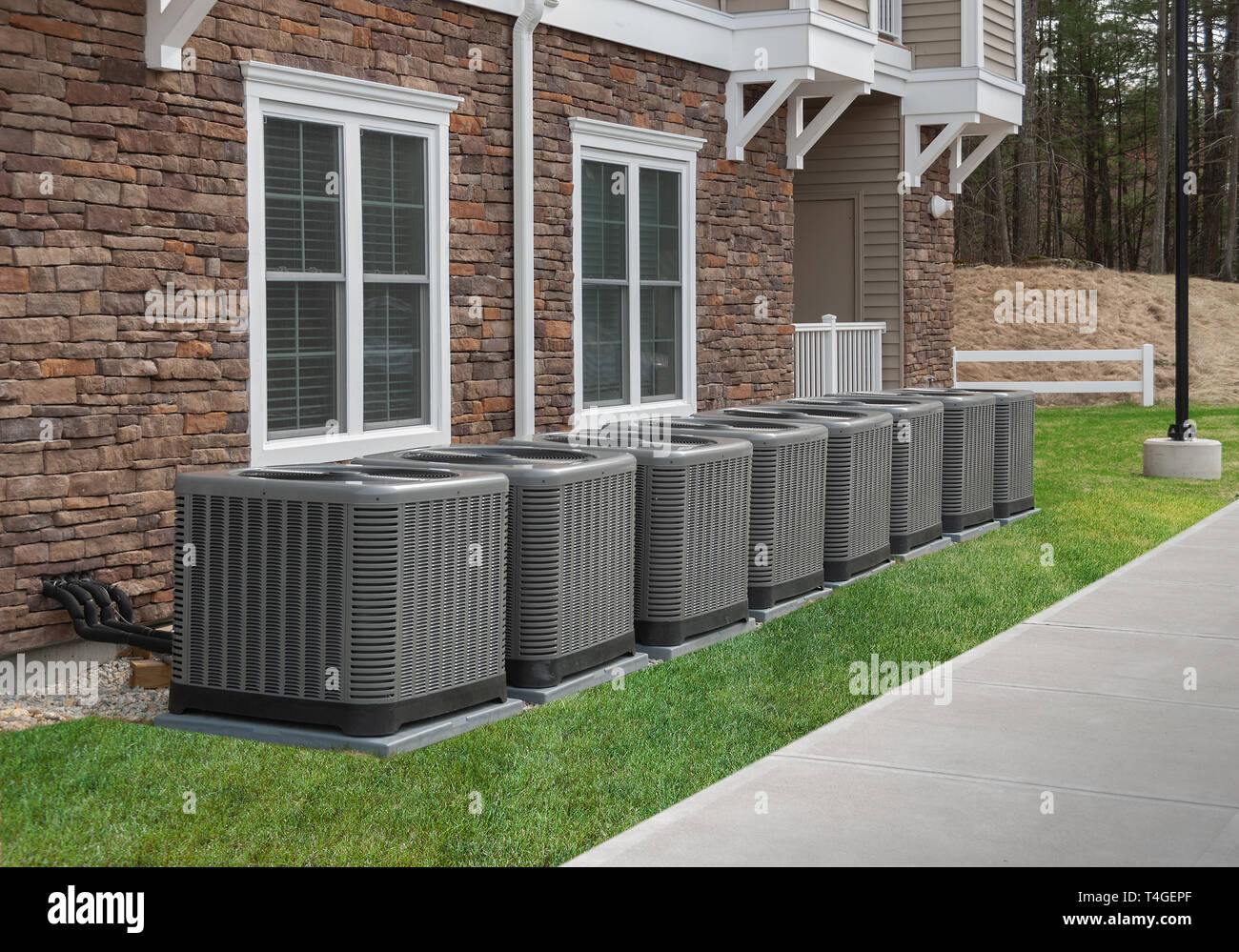 Modern air conditioning and heating units or heat pumps, used in homes and apartments without central air conditioning Stock Photo