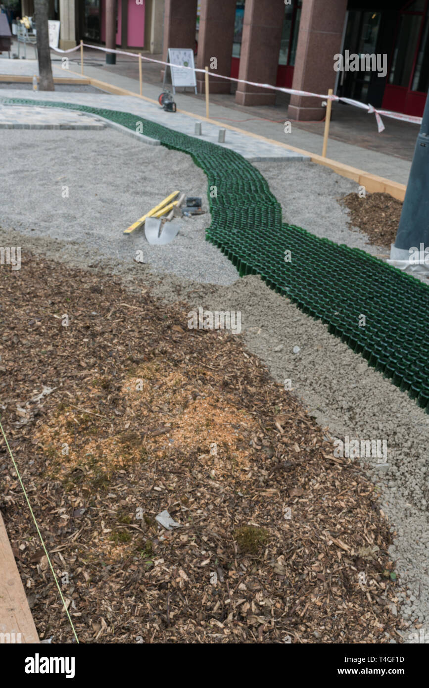 landscape gardening construction site of a natural stone courtyard with an innovative glass bottle walkway Stock Photo
