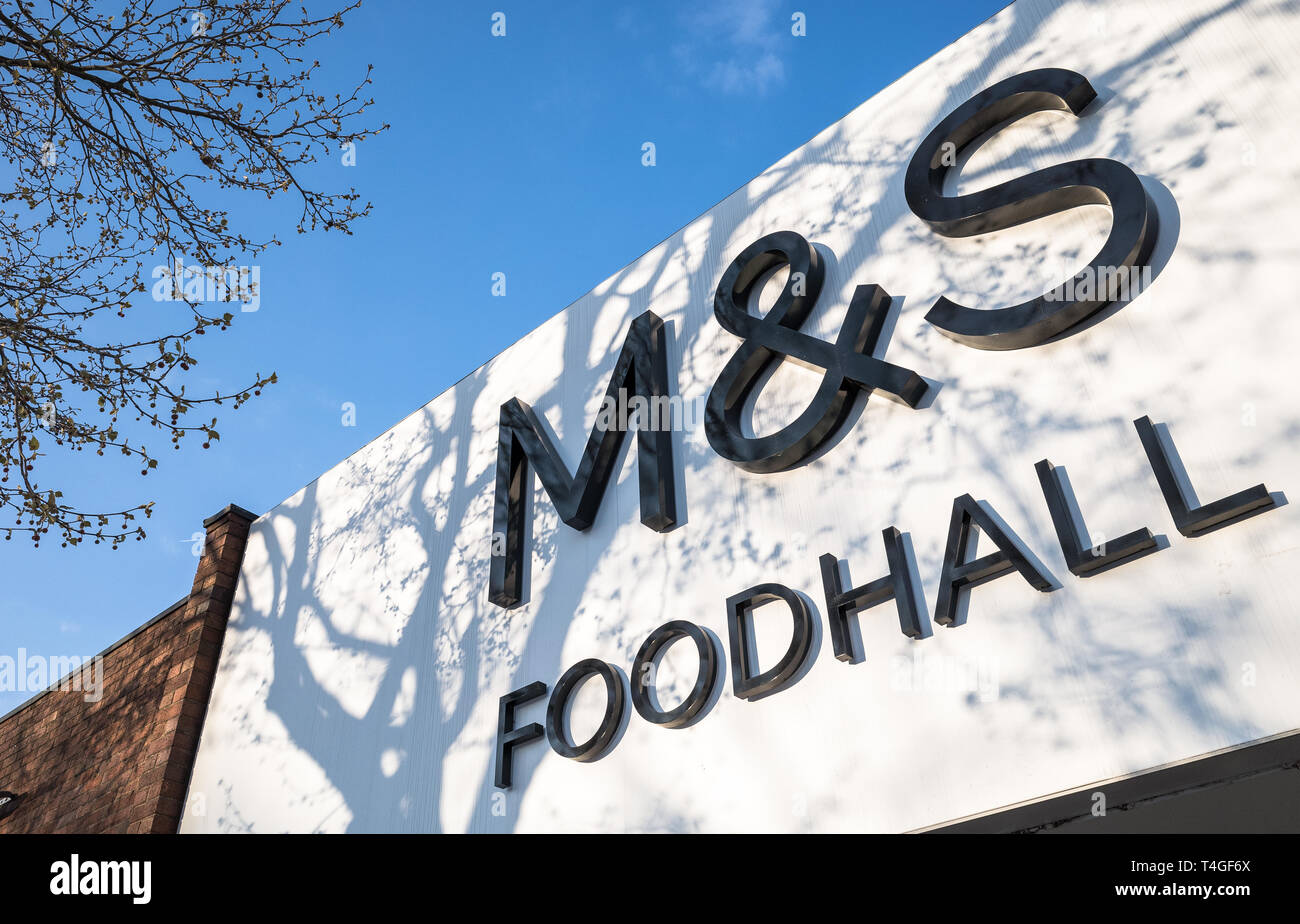 Exterior of a Marks And Spencer food hall with tree shadows. Stock Photo