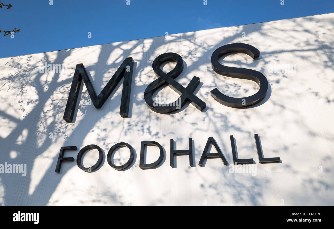 Exterior of a Marks And Spencer food hall with tree shadows. Stock Photo