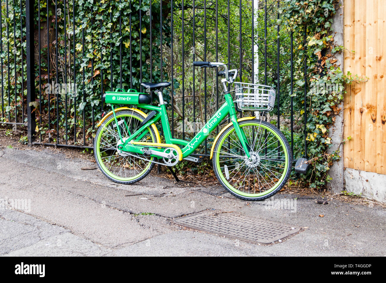 A Lime-E dockless electric assist bike by the side of the road in Highgate, North London, UK Stock Photo