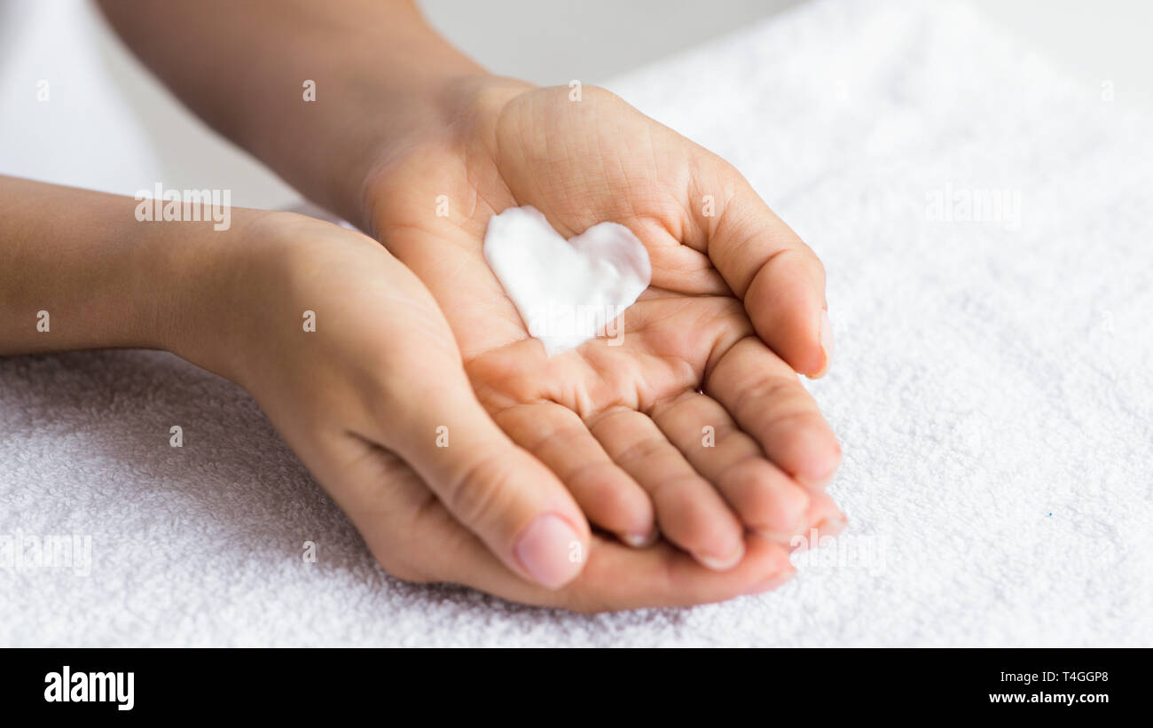 Love your body. Female hands with cream in heart shape Stock Photo - Alamy