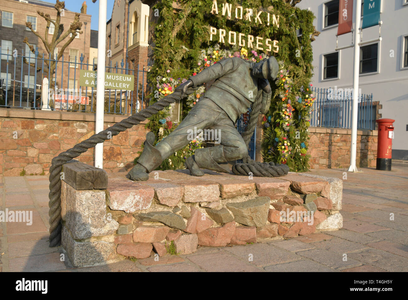 A bronze statue of a sailor outside the Jersey Museum and Art Gallery