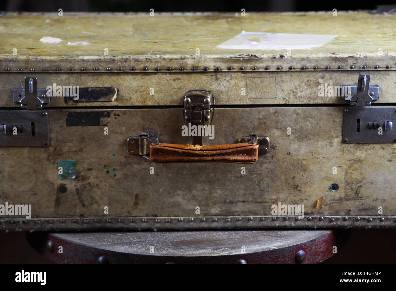 Close up of isolated old used suitcase with rivets, leather grip and ...