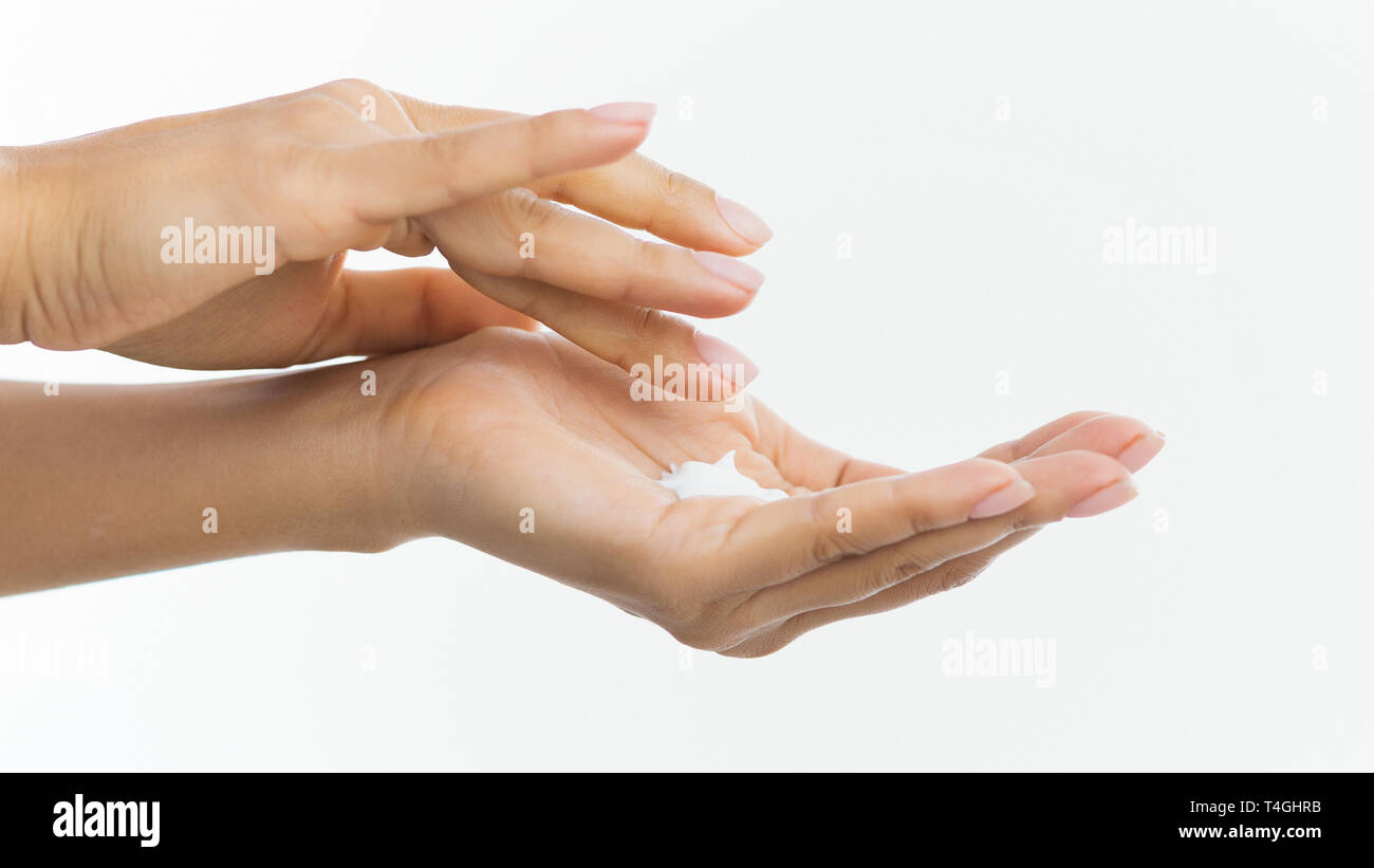 Skin care. Woman applying moisturizing cream to her hands Stock Photo