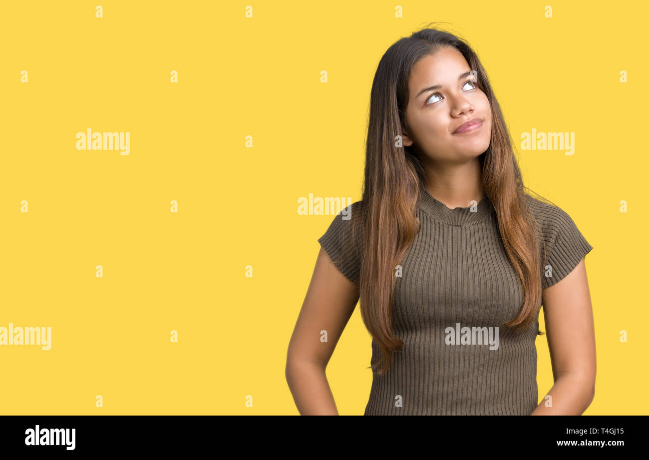 Young beautiful brunette woman over isolated background smiling looking ...