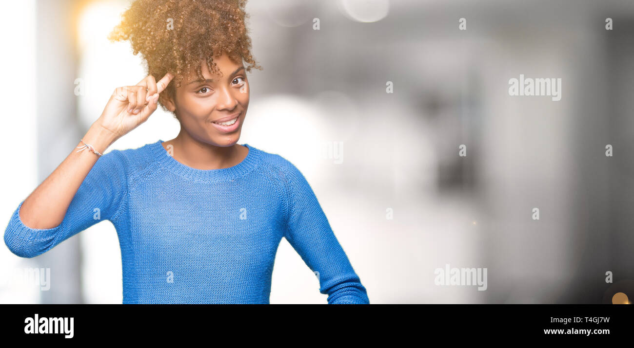 Beautiful young african american woman over isolated background Smiling pointing to head with one finger, great idea or thought, good memory Stock Photo