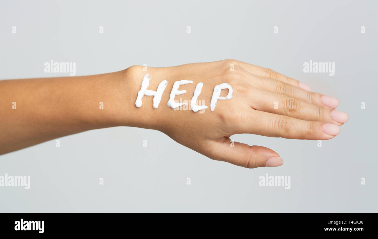 Word help written with cream on female hand Stock Photo - Alamy