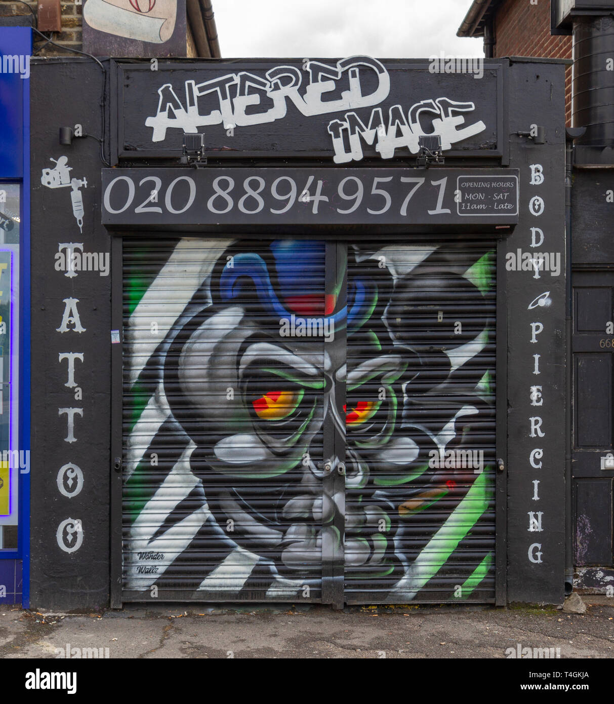 Stunning artwork on the closed shutter of a tattoo shop 'Altered Image'in Hounslow, West London, UK. Stock Photo