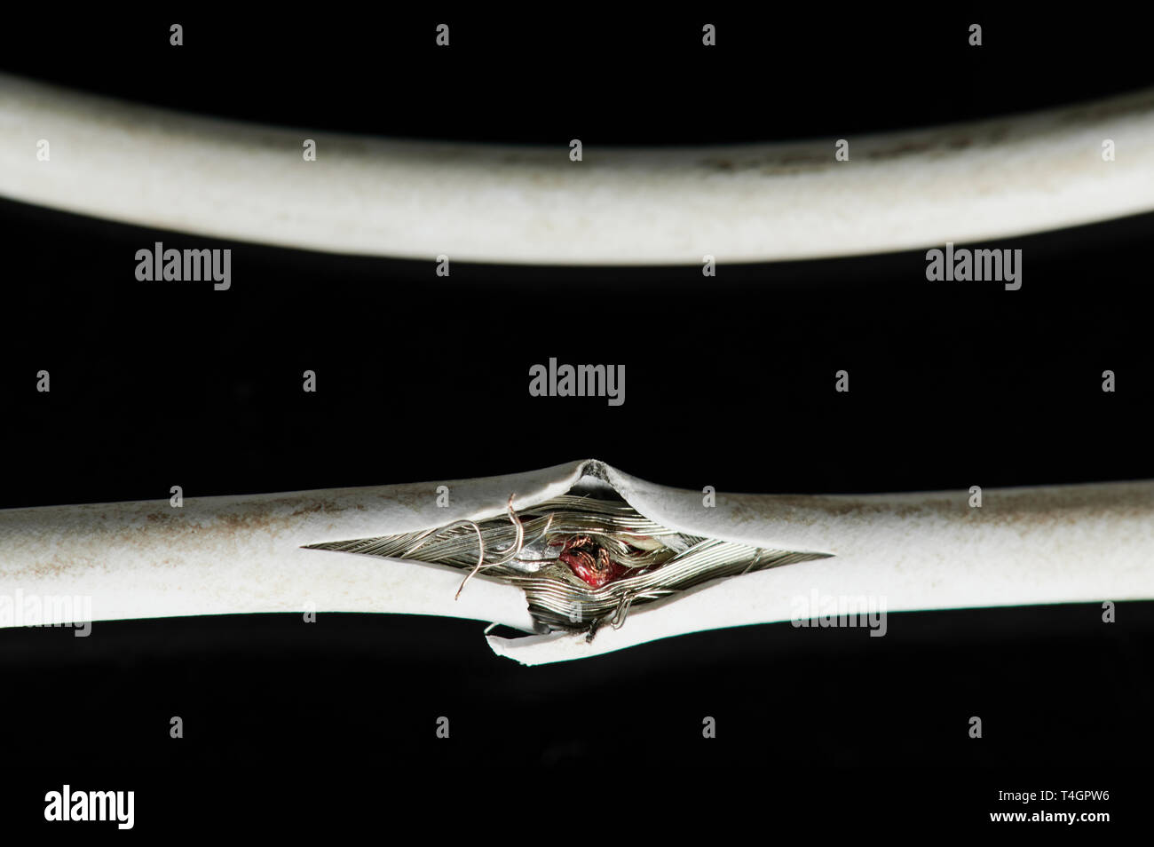 Damaged of white wire cable isolated on black background Stock Photo
