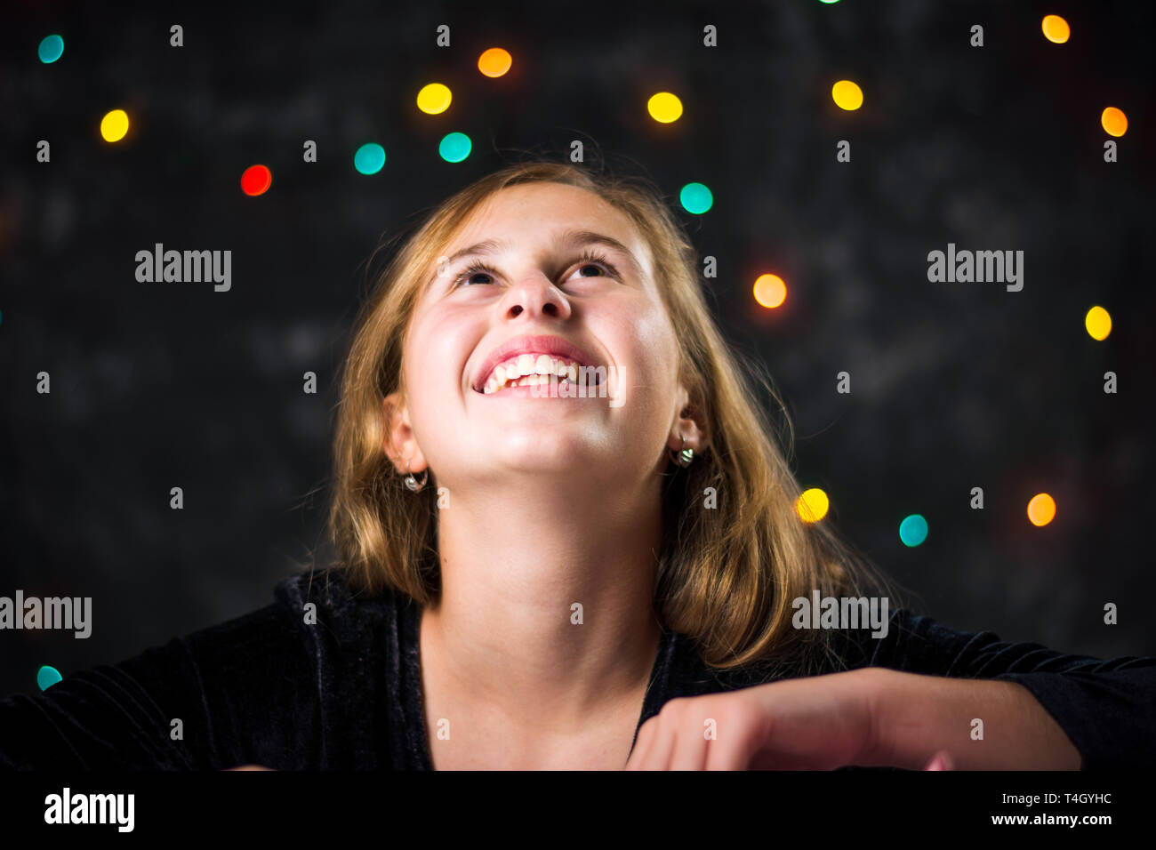 Portrait of cheerful teenage girl against festive background Stock Photo