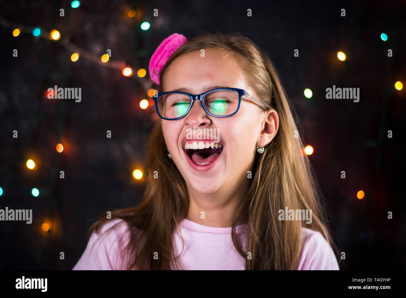 Portrait of cheerful teenage girl against festive background Stock Photo