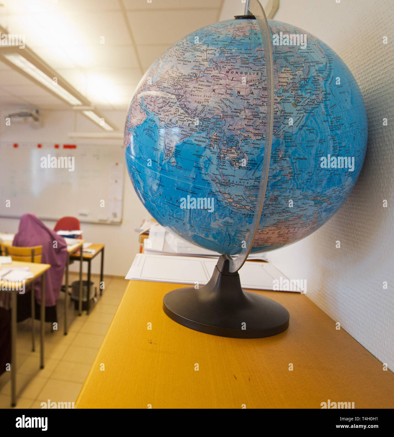 A globe in a classroom. Stock Photo