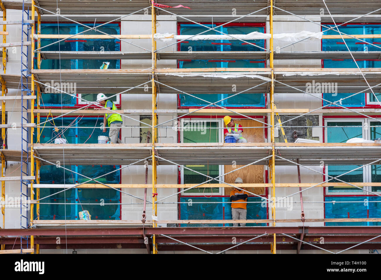 ASHEVILLE, NC, USA-4/11/19:  Workers on scaffolding on the outside of the Arras Building, on Broadway Avenue, near Pack Square. Stock Photo