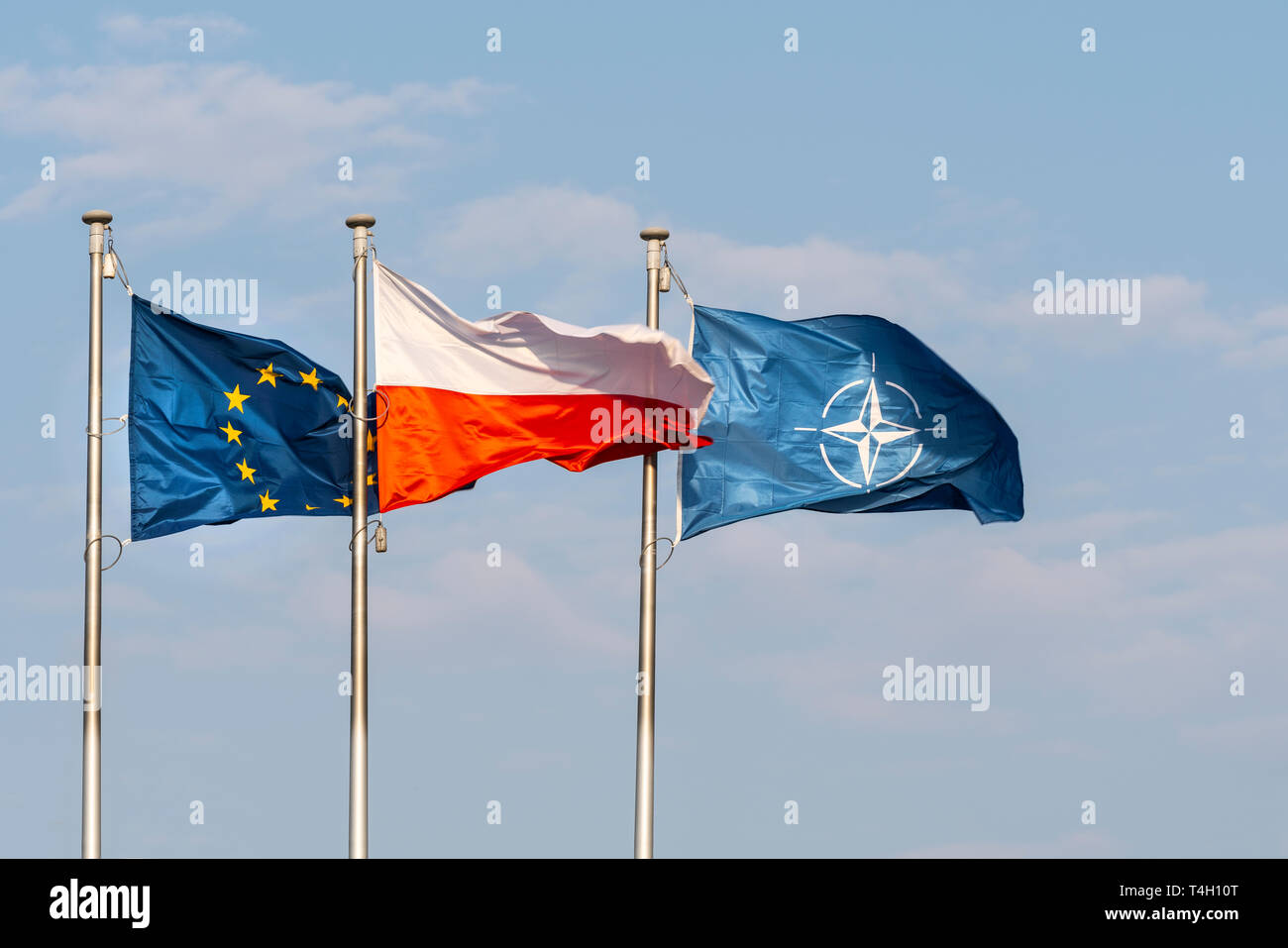 Warsaw, Poland. April 2019.   The flags of Poland, Europe and NATO waving on a blue sky Stock Photo